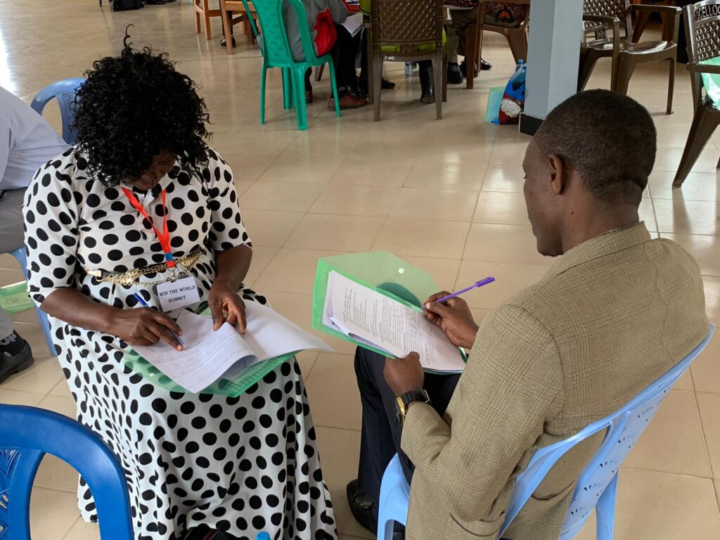 Two participants answering questions during Win the World conferences