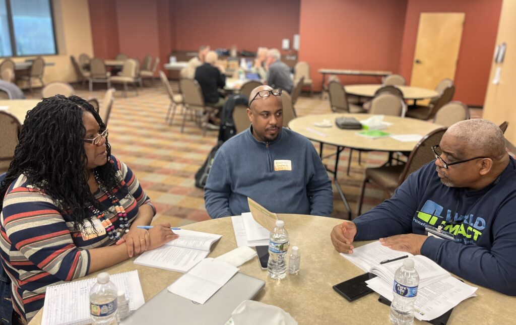 Evangel School of Urban Church Planting students speaking to World Impact staff member