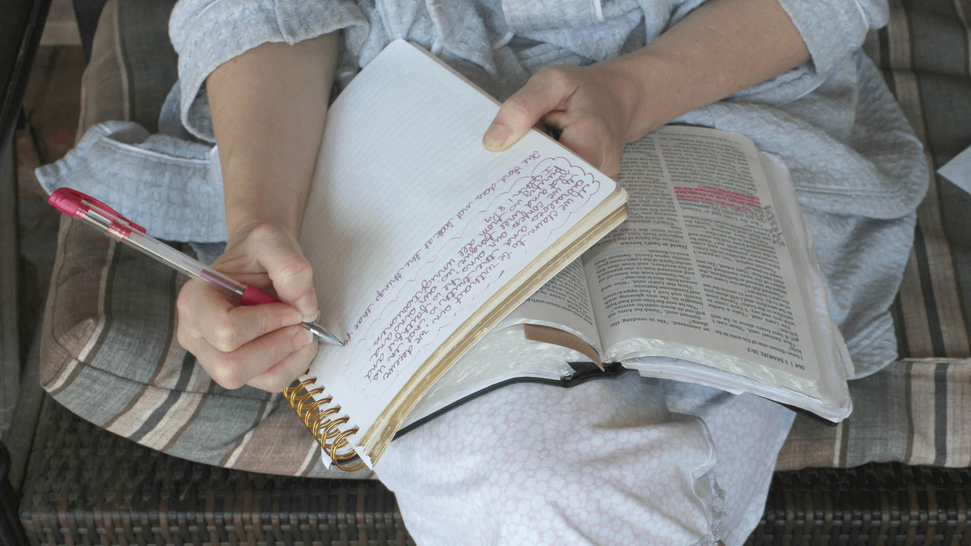 Woman studying the Bible and taking notes.
